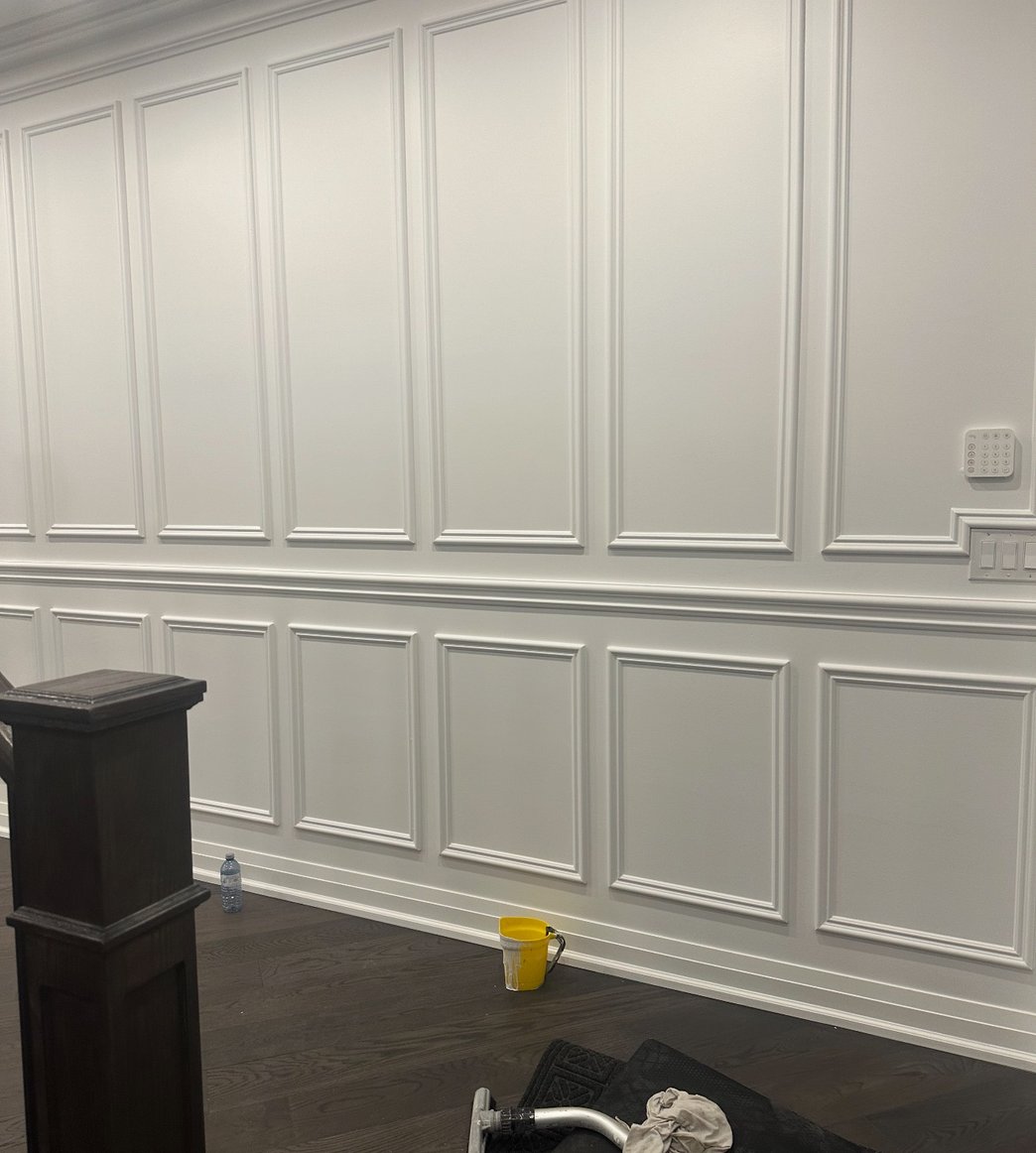 White cabinetry pantry with dark countertops