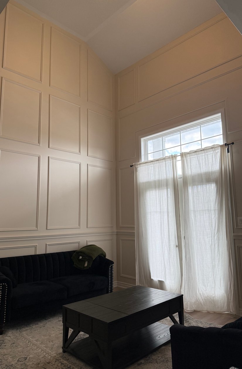 Interior room with light wood floors and glass door to outside