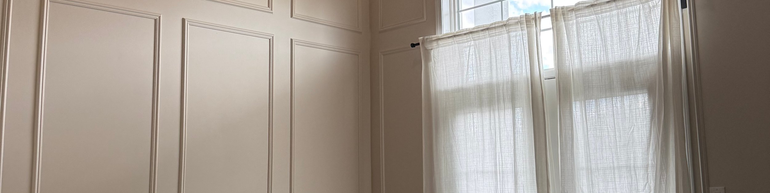 Open interior room with light floors and glass door