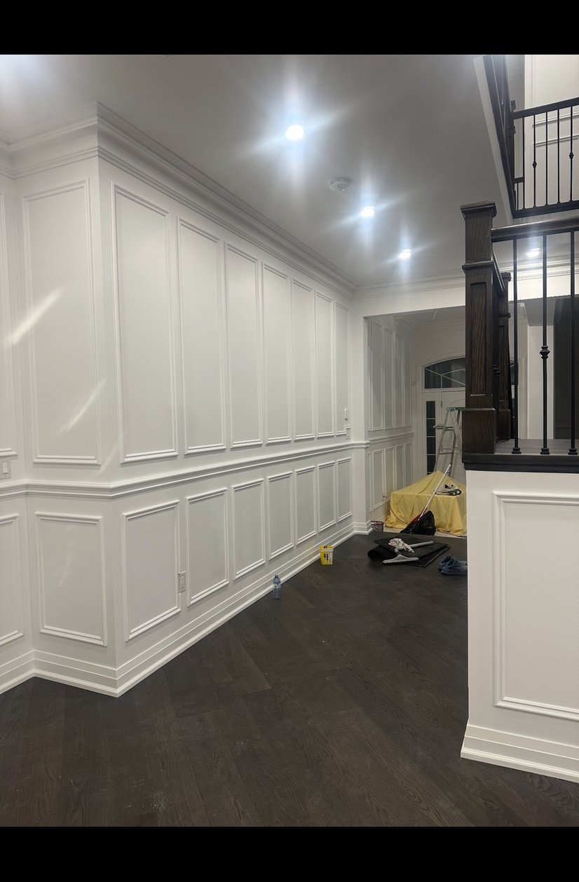 Corner of interior room with light walls and dark door