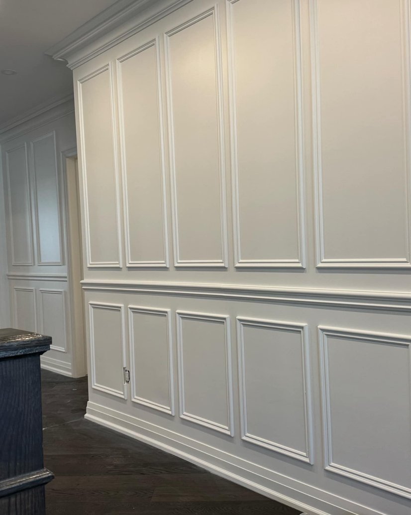 Hallway with light hardwood floors and white walls